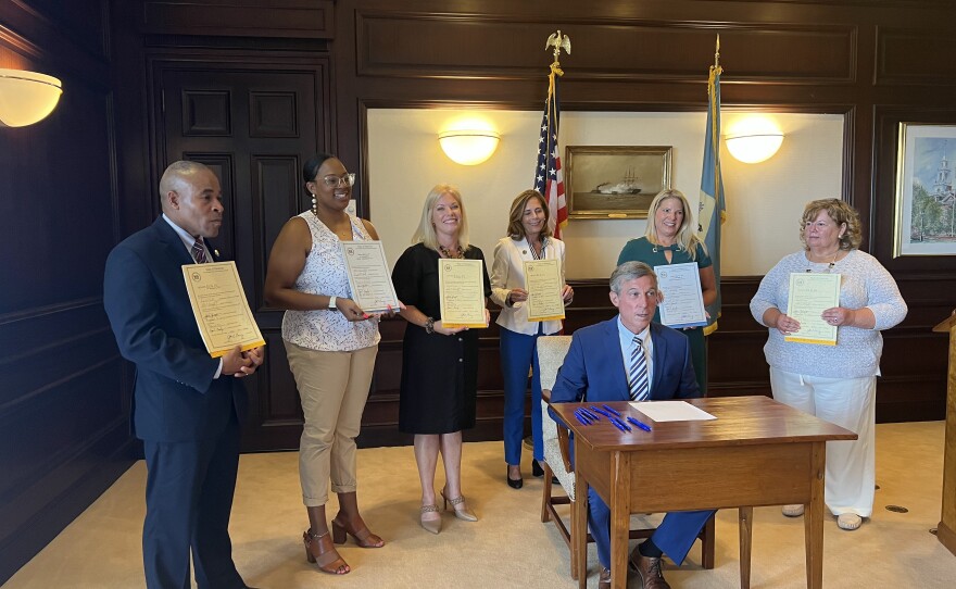 From left to right: Secretary of the Delaware Department of Safety and Homeland Security Nathanial McQueen, Rep. Sherae'a Moore, Sen. Nicole Poore, Attorney General Kathy Jennings, Governor John Carney, and Rep. Valerie Longhurst.