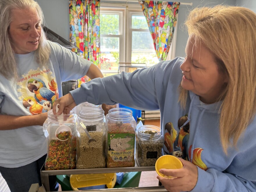 Jodie Owrey, director of parrot care, and Melissa Cheney, the executive director, prepare the parrots' dinner.