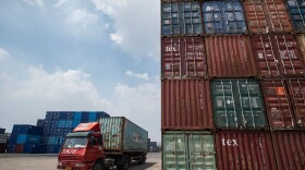 This photo taken on Aug. 7, 2018 shows a truck transporting a container next to stacked containers at a port in Zhangjiagang in China's eastern Jiangsu province. China's trade surplus with the United States eased in July, when President Trump imposed stiff tariffs on billions of dollars worth of Chinese goods in a showdown between the world's two biggest economies. (Johannes Eisele/AFP/Getty Images)
