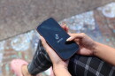 Woman holding phone with TikTok open