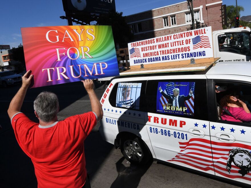 Supporters of Republican presidential hopeful Donald Trump, including gay rights groups, protest against alleged bias outside the CNN offices in Hollywood, California on Oct. 22, 2016.