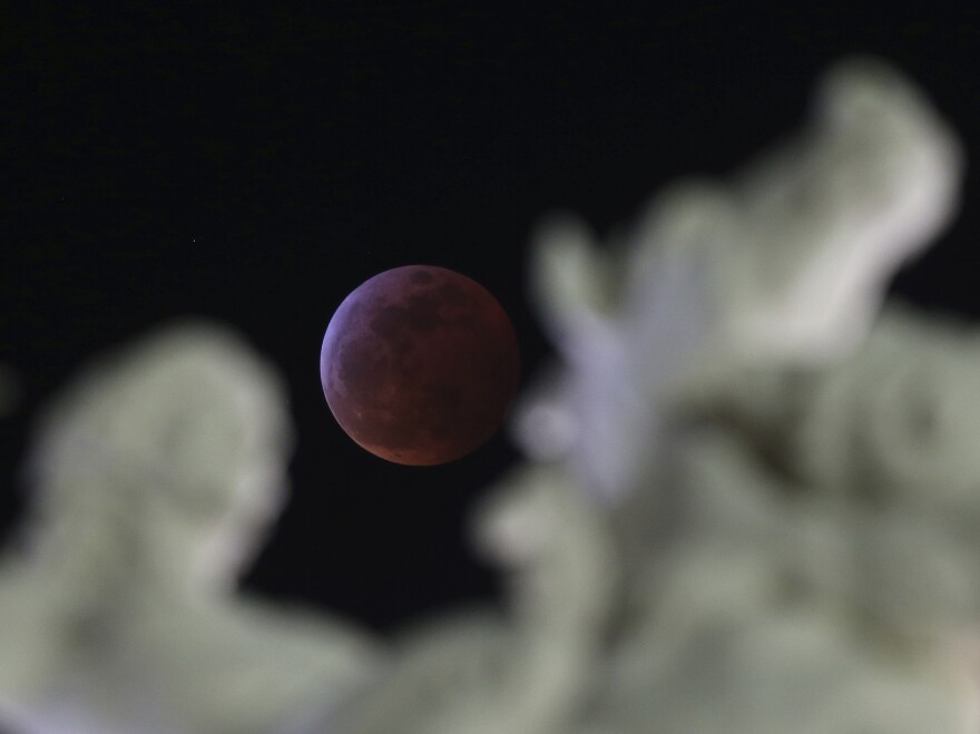The huge moon is framed in a statue in Sacramento, Calif.