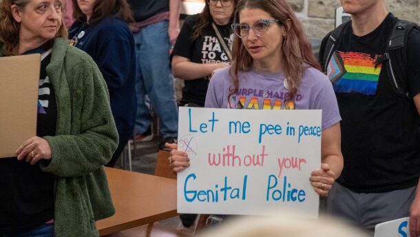 A group of trans activists pose for pictures on Feb. 6, 2026, at the Kansas Statehouse, advocating against a bathroom bill that eventually passed.