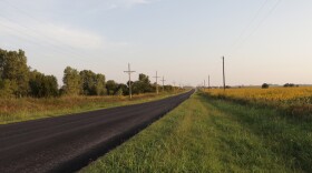Power lines flank this northwestern Oklahoma road. Fiber optic cables can be buried in the ground or hung like power lines. But under new guidelines from the National Telecommunication Information Administration, states are including less fiber in their proposals.