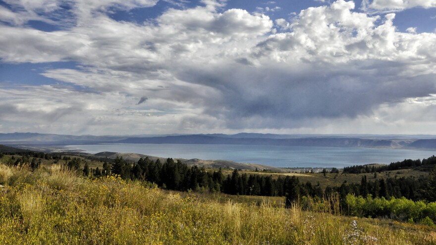 Photo of Bear Lake near Garden City - puffy clouds over a serene blue lake and fields.