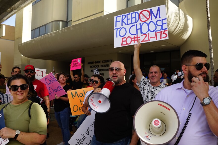 Protesters outside Wednesday's Miami Dade School board meeting. The School Board voted 7-1 to require masks in the classroom for the upcoming school year. 