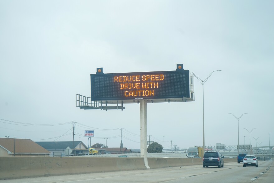  A TxDOT sign on I-35 warns drivers to take caution when driving during the 2023 winter ice storm.