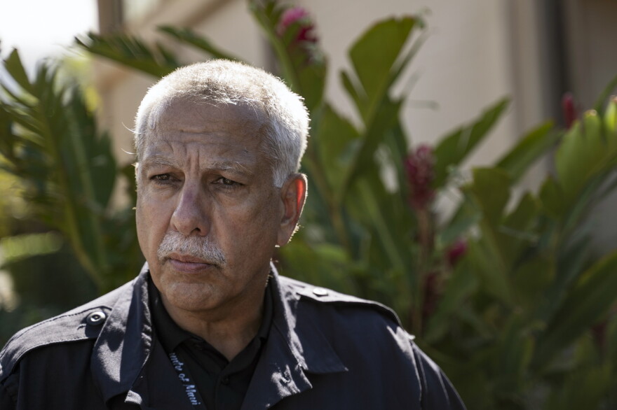 Darryl Oliveira, interim administrator of the Maui Emergency Management Agency, talks to the media at a checkpoint on Kaniau Road, Monday, Sept. 25, 2023, in Lahaina, Hawaii. (AP Photo/Mengshin Lin)