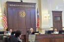 Bexar County Judge Peter Sakai, center, presides over county commissioners meeting at the county courthouse