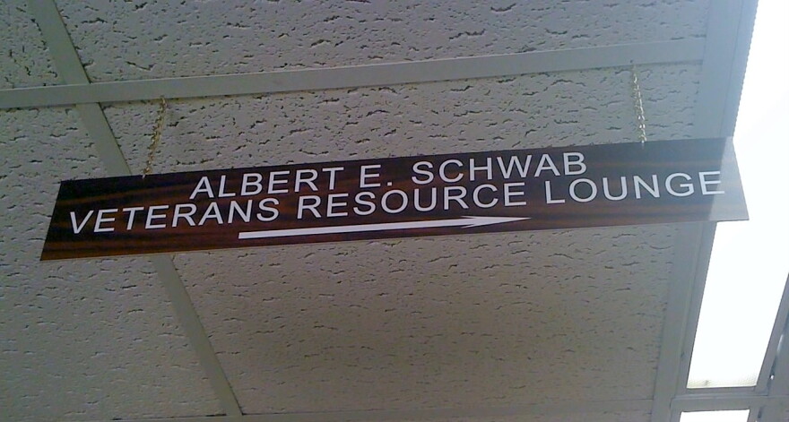 A sign hangs from the ceiling title marking the new Veterans Center on the TU campus.