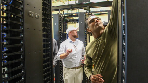Fletch Batchelor (center) shows students around Louisiana Delta Community College's mock data center on Aug. 18, 2026.