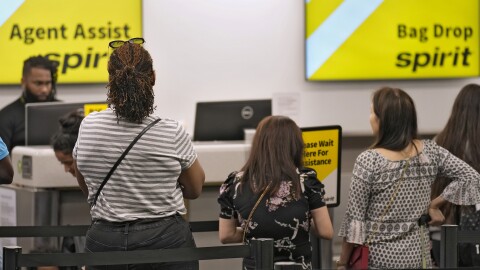 FILE - Passengers wait in a line for help at the Spirit Airlines ticket counter at the Tampa International Airport Thursday, June 1, 2023, in Tampa, Fla.