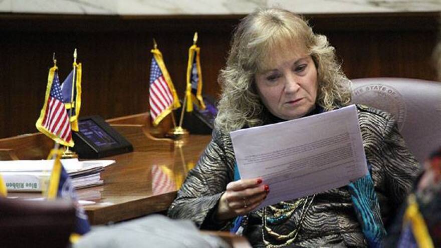 State Superintendent Glenda Ritz reads through a report drafted by her colleagues on the 2015 Blue Ribbon Commission.