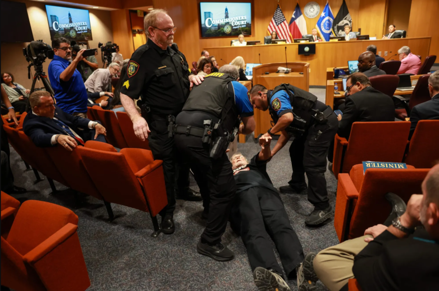 Lon Burnam, former Texas House representative, is arrested during a Tarrant County Commissioners Court meeting Aug. 4, 2026, in Fort Worth.