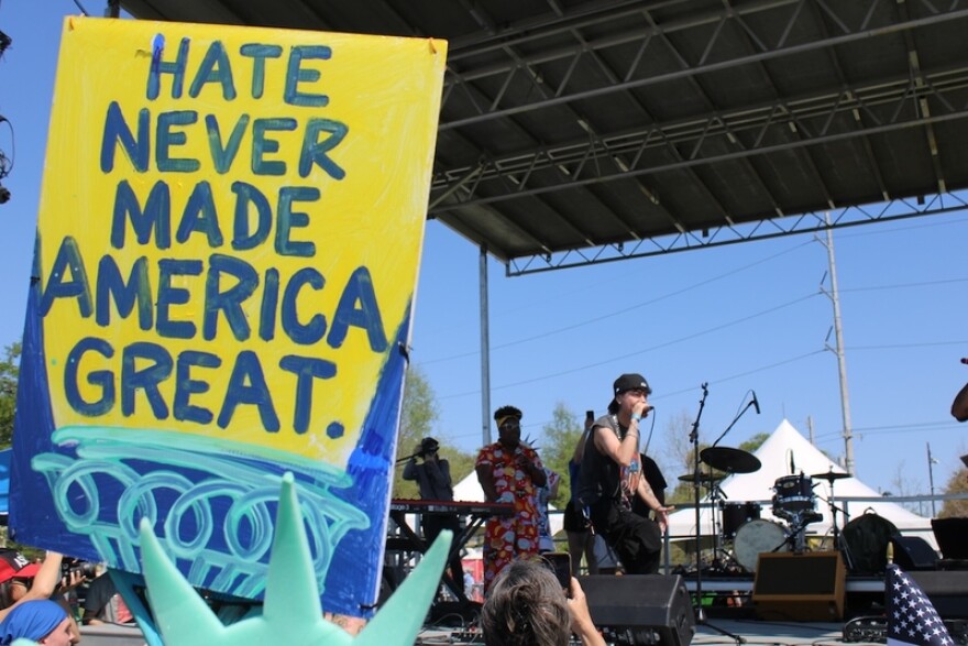 Damian Ch performs on stage for the New Orleans No Kings event, where thousands gathered along the Lafitte Greenway. (Photo by Greg LaRose/Louisiana Illuminator)