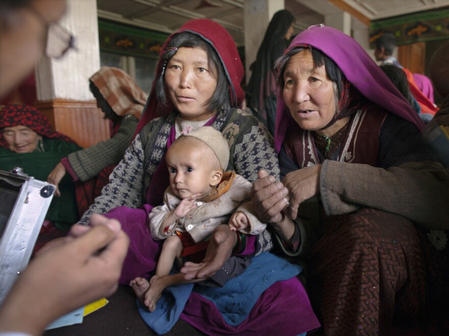 Dr. Mohammed Rashidi talks to a mother about her severely malnourished baby at a makeshift mobile health clinic in a remote village in Afghanistan's Bamiyan province last year. 