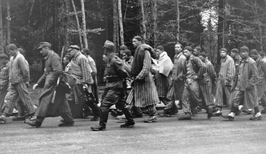 Nazi guards force Jewish prisoners on a death march during World War II. The fifth man from the right is Leo Wolf, who survived the Holocaust and co-founded the Holocaust Museum & Learning Center with Tom Green and Bill Kahn. 