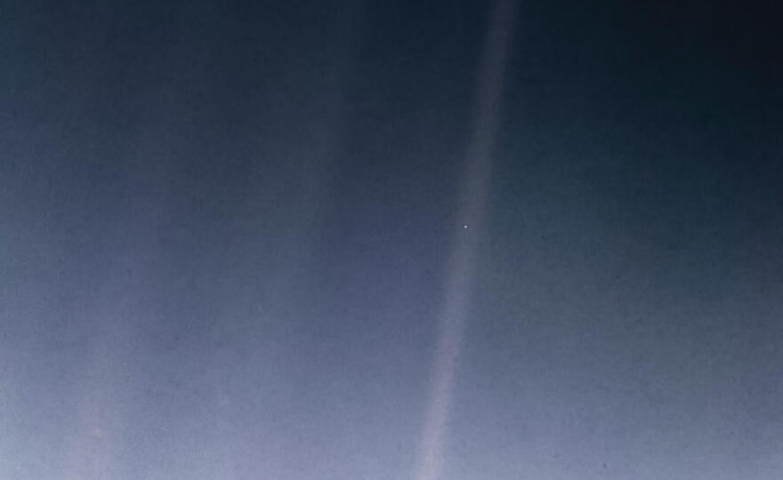 Earth, as seen in 1990 from the interstellar probe Voyager 1, in the image known as "The Pale Blue Dot."