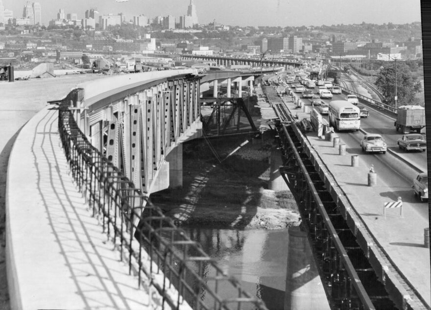 A Daily Traffic Jam And Its Ultimate Solution Are Seen In This View Of The Two Intercity Viaducts, The Original On The Right And The New One, Partly Completed, On The Left. Typical 5 "oÕclock Traffic Clogs The Three Lanes Remaining Open During Constrution. Here, Westbound Traffic Must Funnel Into One Lane. A Similar Situation Has Resulted In Bumper-to-bumper Traffic At The East End. Paving Has Been Completed On The New Span And A Ramp Leading To The Kansas Turnpike. A Sidewalk Has Been Provided For Pedestrians. When The Project Is Finished A Motorist Will Be Able To Travel From The Paseo Bridge In Kansas City To The Oklahoma Line, About 240 Miles, Without Encountering A Traffic Signal Or Stop Sign. Completion Of The Viaduct Is Planned For Late In 1962.
