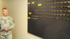 Lt. Col. Hamby stands next to a board displaying the names of Ft. Campbell soldiers killed. He says 248 have died since the war began.