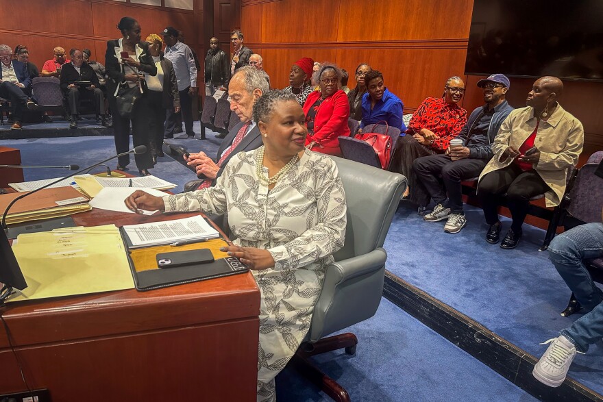 Connecticut Chief Public Defender Tashun Bowden-Lewis looks over at a group of supporters before a hearing at the Legislative Office Building in Hartford, Conn. on August 16, 2024, on whether she should keep her job mid allegations of misconduct. Many in the audience were Black women who wore red in support of Bowden-Lewis.