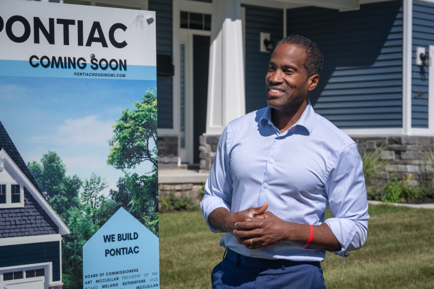 Congressman John James (R-MI 10) stands outside a newly-constructed home in Pontiac in September 2026.