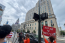 Protestors gather outside the Virginia General Assembly building ahead of a meeting of the Virginia Energy Commission to oppose the merger between Virginia's Dominion Energy and Florida's NextEra.