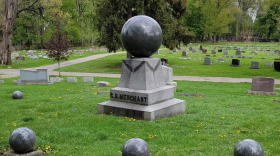 Several graves are shown inside a cemetery.