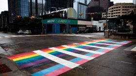 A crosswalk at 4th and Colorado streets with the colors of the Pride flag.