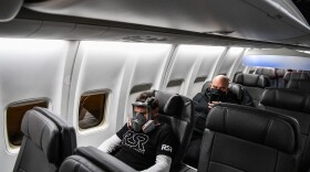 A man wears a gasmask as he travels in a flight from Miami to Atlanta in Miami, on April 23, 2020. (CHANDAN KHANNA/AFP via Getty Images)