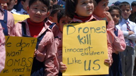 Pakistani school children carry placards during a protest at the site of the demolished compound of slain Al-Qaeda leader Osama bin Laden in northern Abbottabad on May 2, 2012 on the first anniversary of the death of Osama bin Laden.