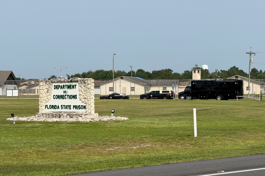 FILE - Law enforcement vehicles sit parked outside the Florida state prison in Starke, Fla., on Tuesday, July 28, 2026.