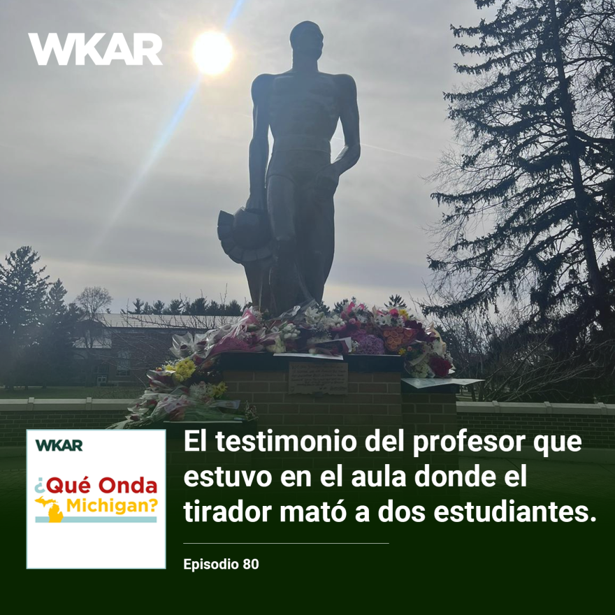  En la imagen se puede observar el monumento de Spartan en Michigan State University. El monumento esta rodeado de flores y mensajes a las victimas que murieron cuando un tirador entro a la universidad.  En el lado inferior de la imagen esta el logo de ¿Qué Onda Michigan? sobre un fondo blanco. En la parte derecha las siguientes palabras estan escritas: "El testimonio del profesor que estuvo en el aula donde el tirador  mató a dos estudiantes." En el lado superior de la imagen se encuentra las palabras "WKAR" en color blanco.  y "Episodio 80".