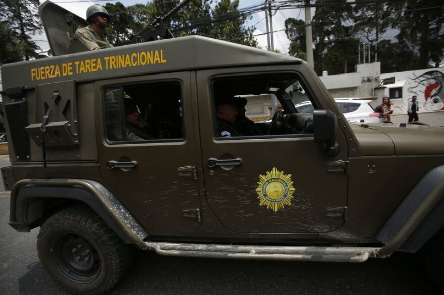Guatemalan military vehicles surround the anti-corruption mission in Guatemala City on Friday.