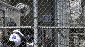 FILE - In this Wednesday, April 10, 2019 file photo, Prison staff work at Lee Correctional Institution in Bishopville, S.C. South Carolina officials gave initial approval Tuesday, June 29, 2021, to a $6 million settlement to resolve dozens of prisoner lawsuits against the Department of Corrections following a riot that killed seven inmates. (AP Photo/Meg Kinnard, File)