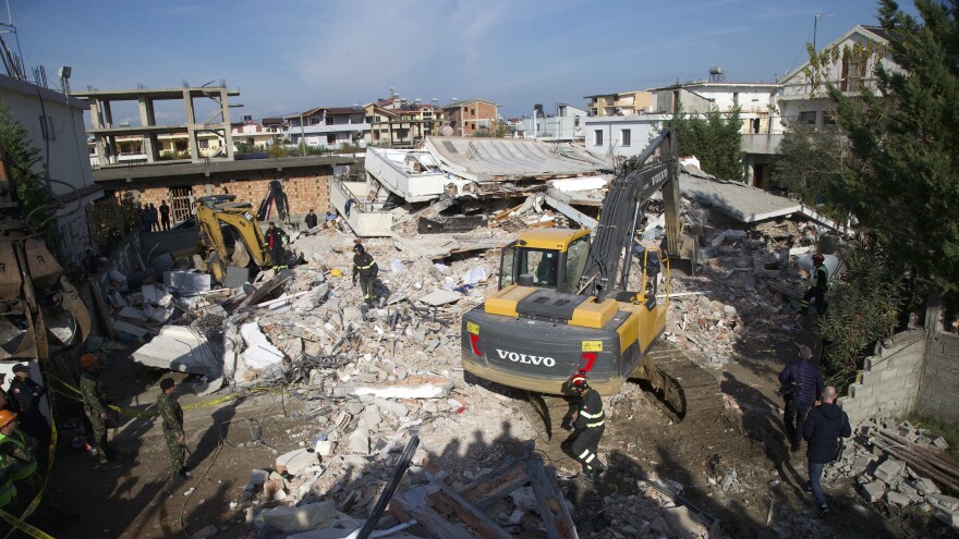 Rescuers search a collapsed building for survivors in Durres, Albania, on Wednesday. More than two dozen people have been reported dead in the country after a powerful earthquake rocked the country earlier this week.
