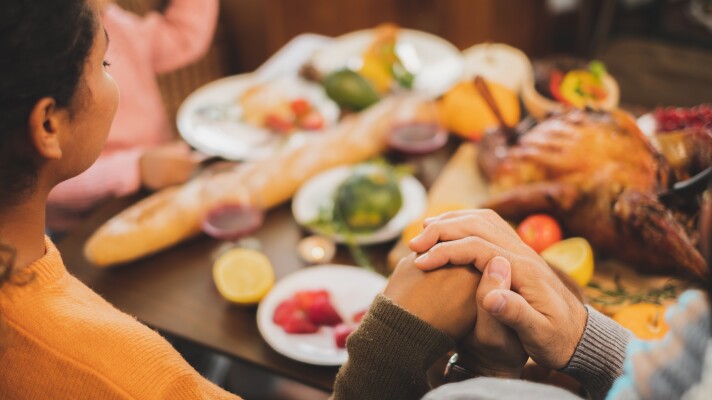 Happy Thanksgiving dinner at home, praying and blessing before having dinner