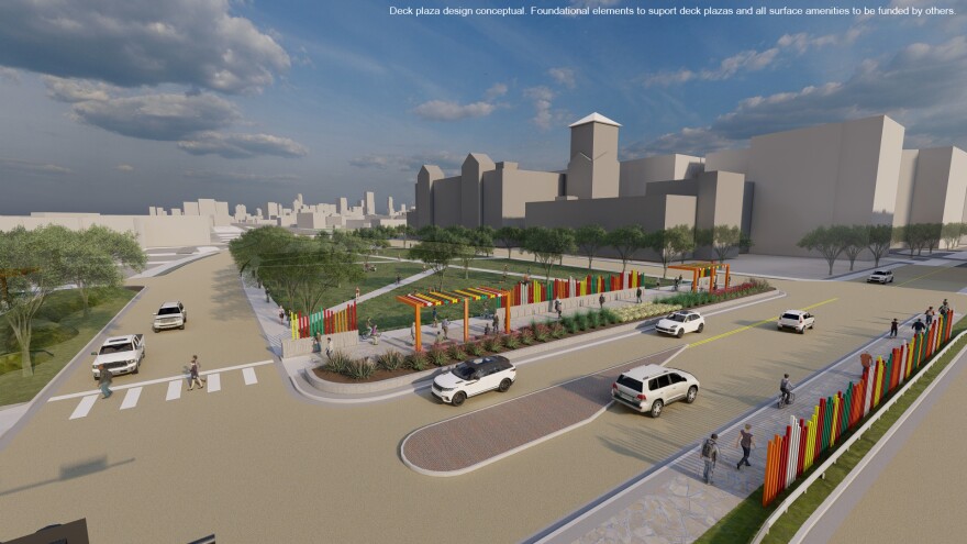 An illustration showing cars driving on a conventional looking street grid. No freeway is in site. Background buildings lack detail. They're simply depicted as white blocks for the purpose of the rendering.