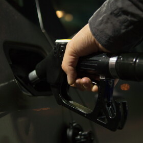 Pumping gasoline for a vehicle.