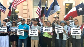 Landowners and other supporters hold signs against the Trump administration's plans to build a border wall and other infrastructure in Texas' remote Big Bend region, Monday, Sept. 14, 2026, in Marfa, Texas. (AP Photo/Rebecca Santana)