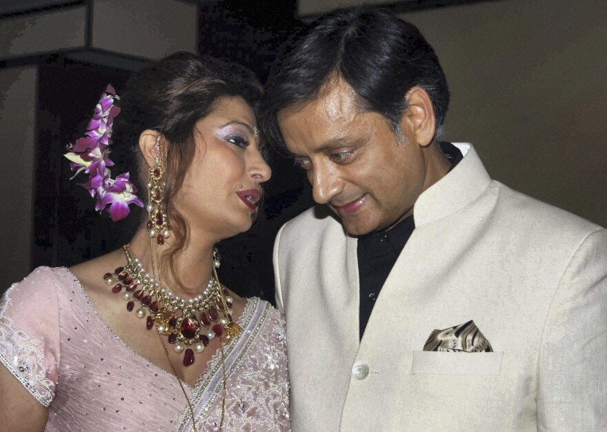 Shashi Tharoor listens to his wife Sunanda Pushkar at their wedding reception in New Delhi, India in 2010.