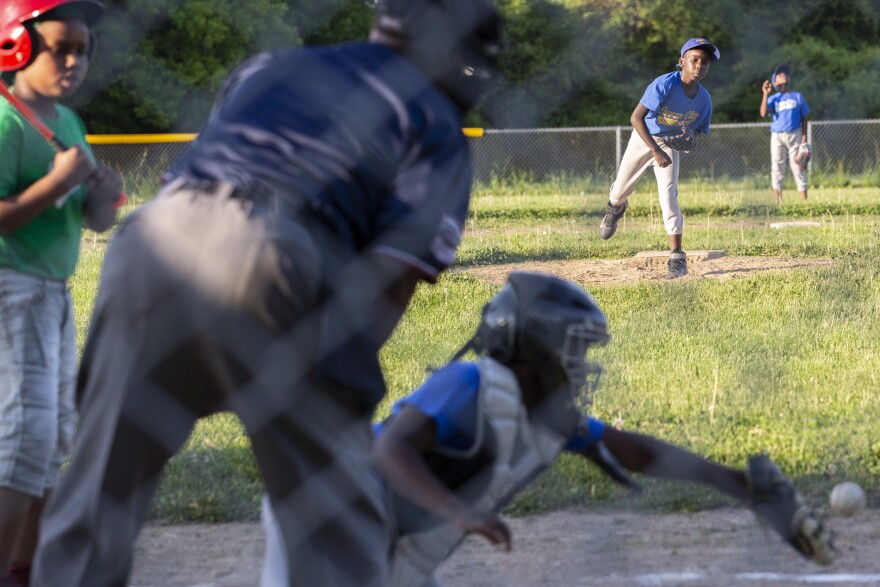 Tahjere Dowdell, 11, throws a few pitches to catcher Ga'verri Jones-Collins between innings.