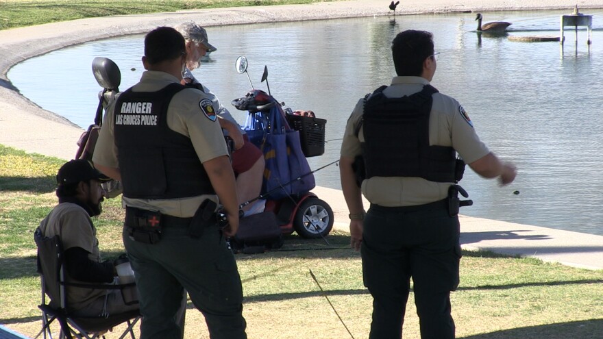 Park rangers speak with visitors at Young Park