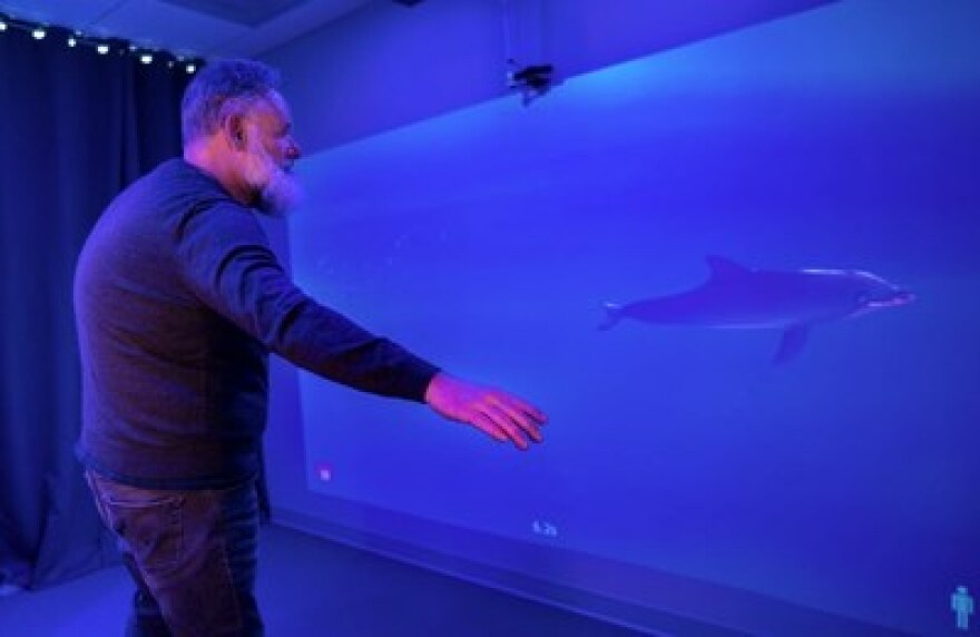 A man uses the MindPod game, I Am Dolphin, by MindMaze. Credit: MindMaze