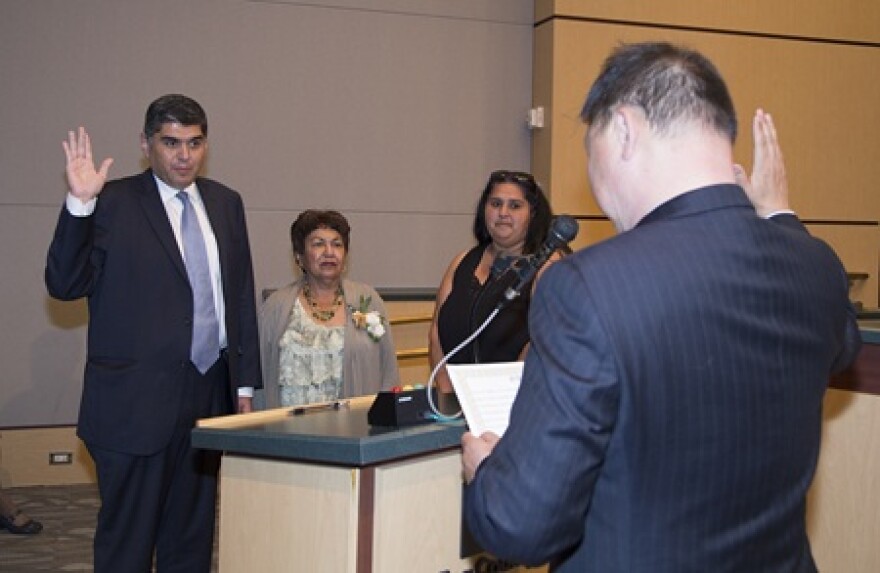 State Rep. Javier Valdez is sworn in by Judge Dean Lum