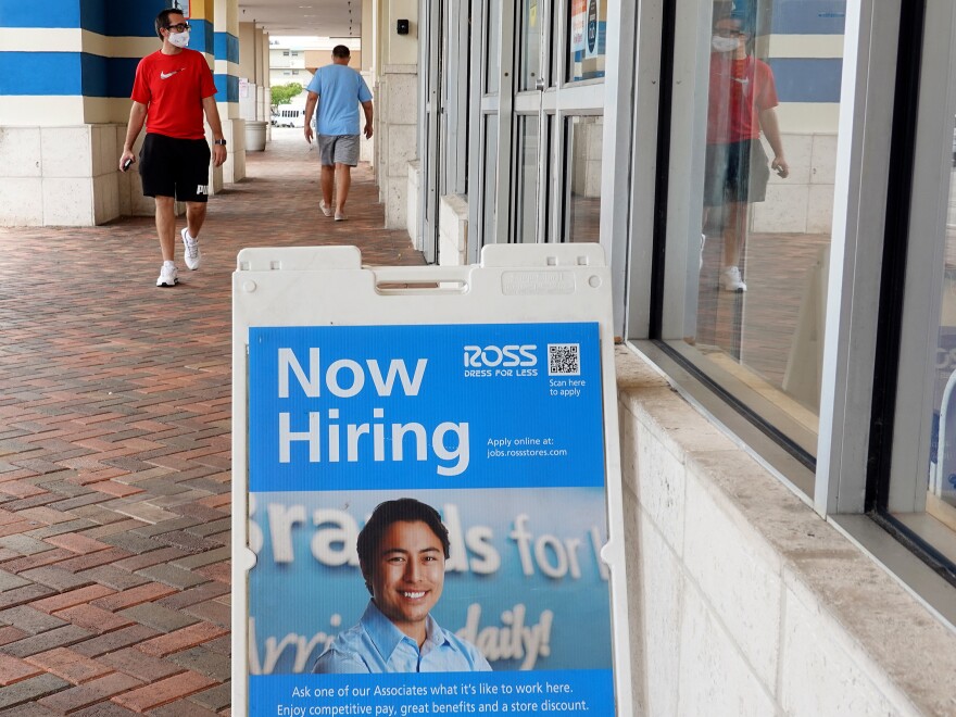 A "Now Hiring" sign is shown near the entrance to a Ross department store on Sept. 21, in Hallandale, Fla. Employers added far fewer jobs than expected in August as the Delat variant continues to spread.