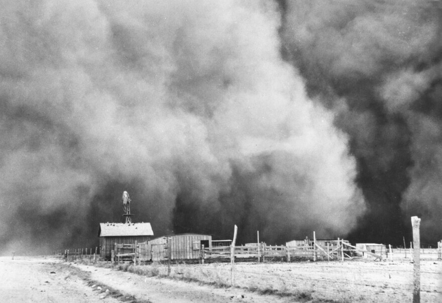 Looming dust storm clouds roll near a farm.