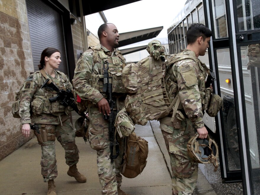 U.S. Army soldiers board a bus in January 2020 at Fort Bragg, N.C., one of the military bases that will likely see population boosts in their 2020 census counts due to a change to how troops deployed abroad were counted.