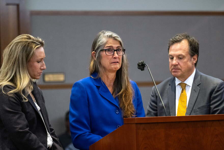 Former Colorado Bureau of Investigation forensic analyst Yvonne "Missy" Woods cries as she gives a personal statement with her lawyers Lindsay Brown and Tom Ward seated besides her.