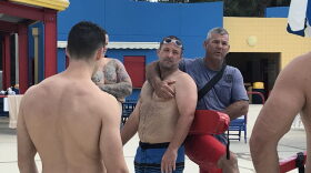 Training instructor Robert Osteen, right, demonstrates how to rescue someone from a pool. (Valerie Lyons/WUFT News)